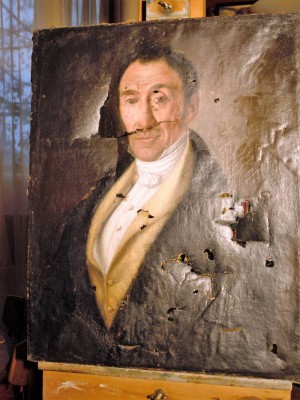 Portrait of a man c.1800 showing tears and holes before treatment.