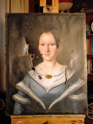 Portrait of a woman c.1800 before treatment, showing holes and tears.